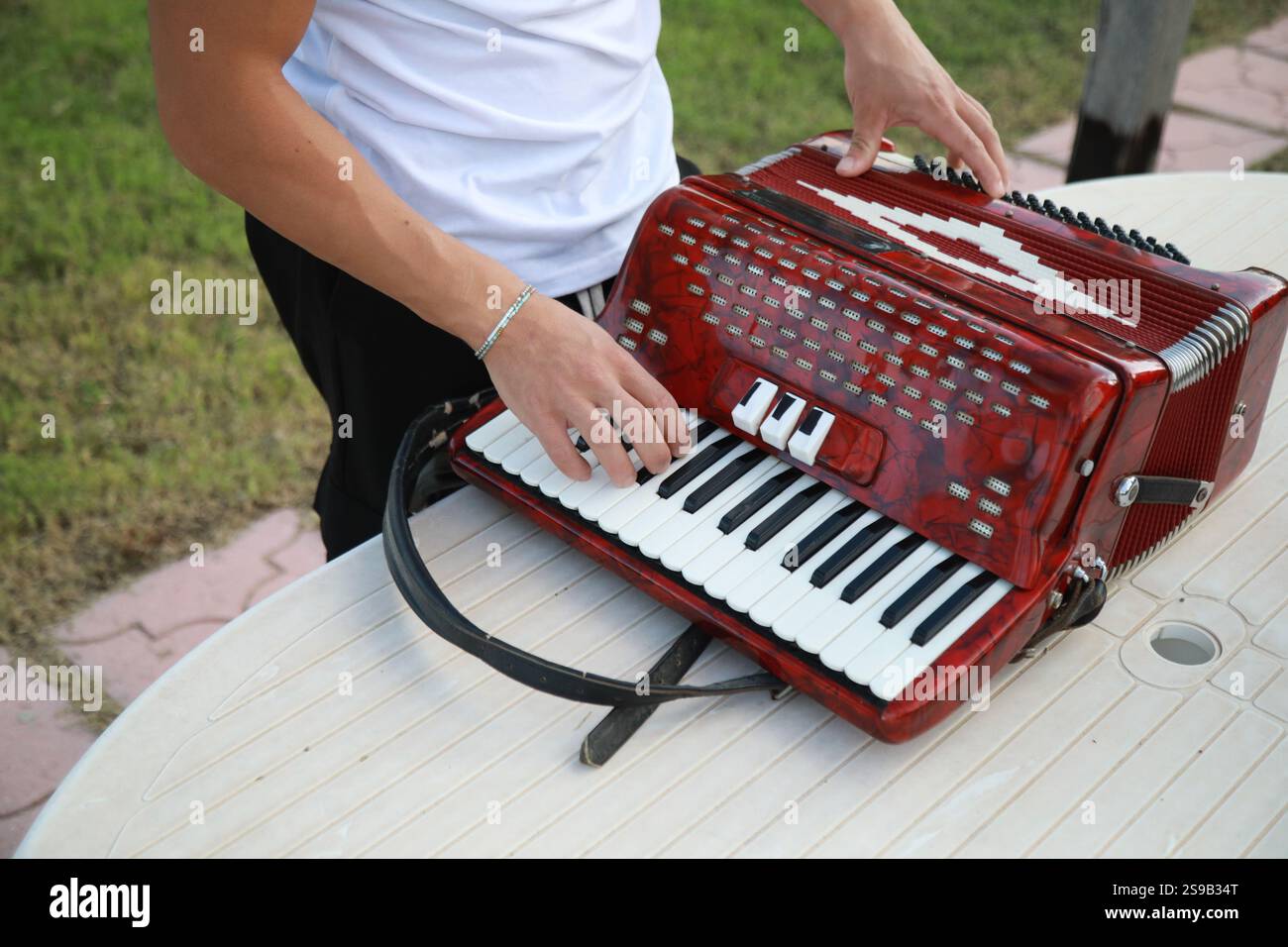 Man Testing All The Buttons Of His Accordion Stock Photo - Alamy