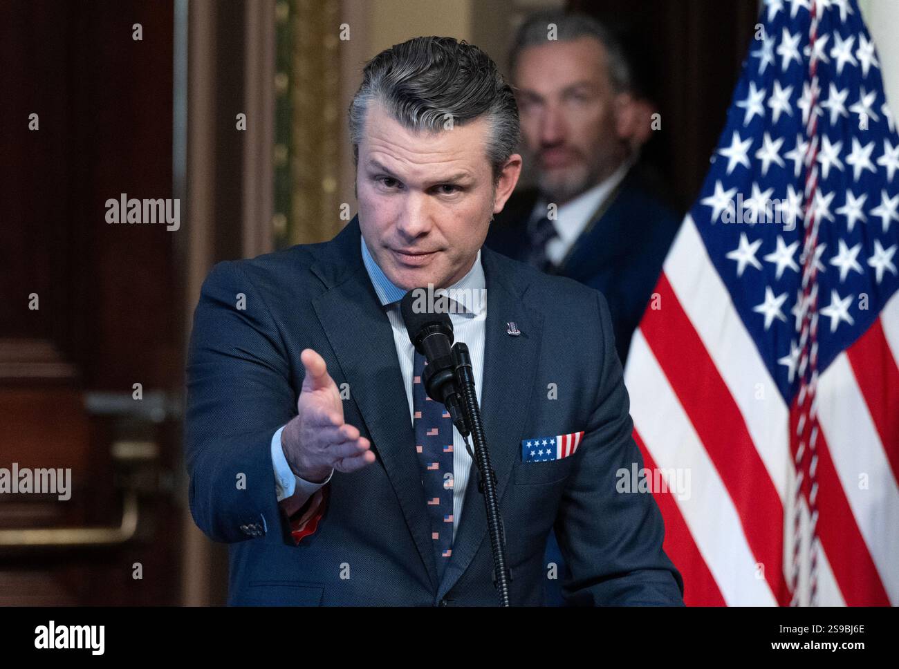 United States Secretary of Defense Pete Hegseth, left, makes remarks