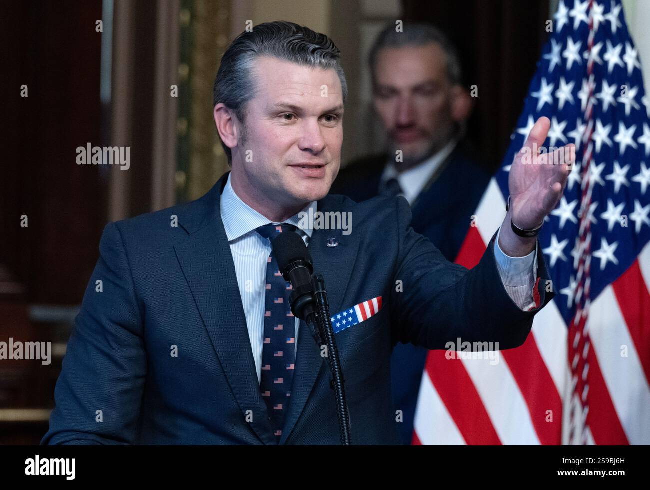 United States Secretary of Defense Pete Hegseth, left, makes remarks