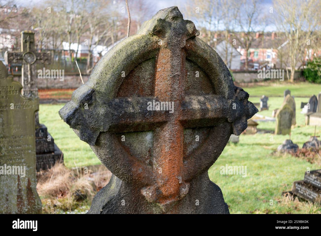 Victorian gravestone with a stone cross carving at Blackburn Cemetery. Stock Photo