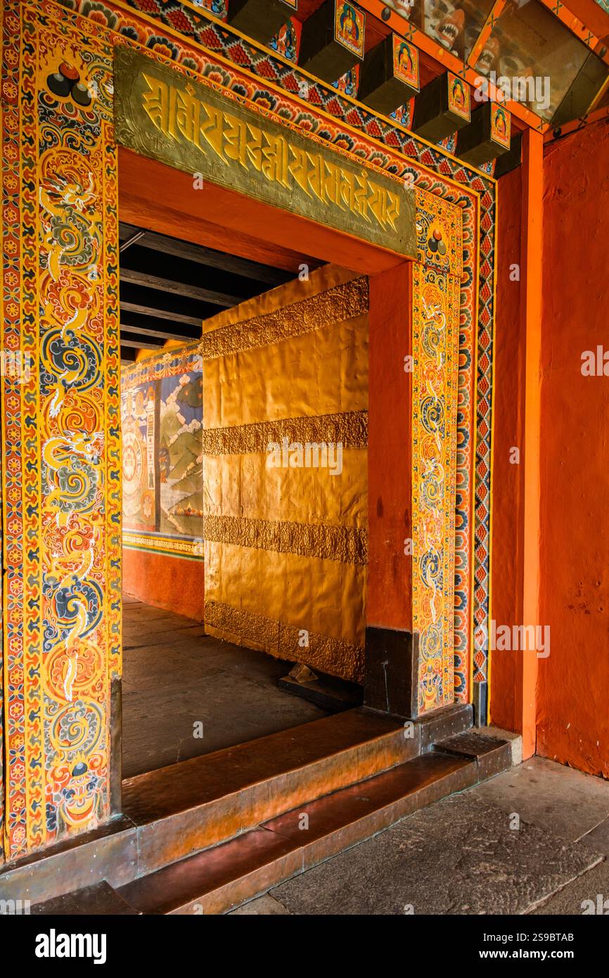 Colorful entrance and golden door lead to interior passageway inside Punakha Dzong, Bhutan Stock Photo
