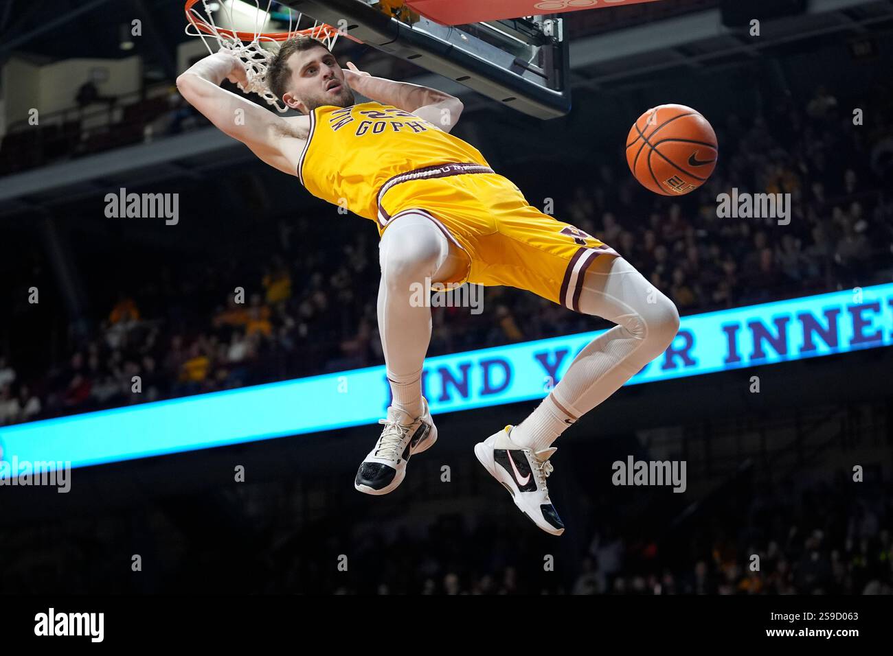 Minnesota forward Parker Fox (23) hangs on the rim after a dunk during