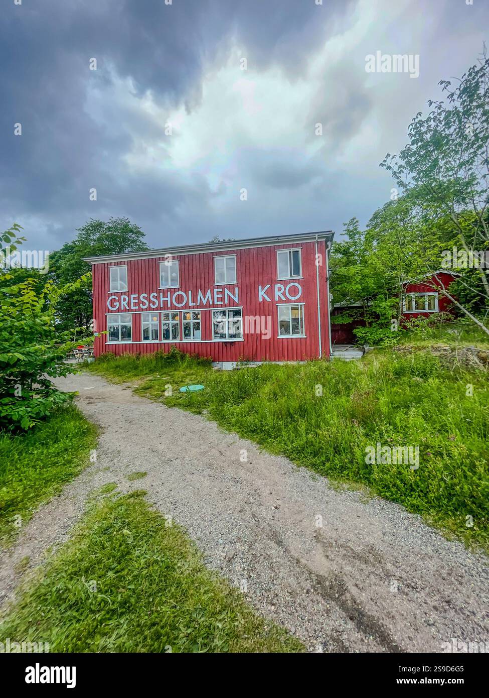 Relax and enjoy a meal at the Gressholmen café, a charming waterfront stop on Oslofjord's peaceful island, offering stunning views and local flavors - Smartphone Captured Stock Image