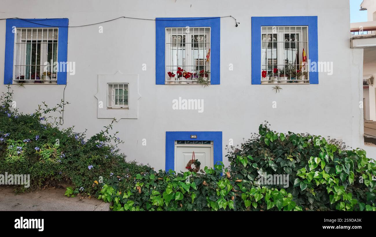 A typical residential house in Granada, Spain, featuring a white wall ...