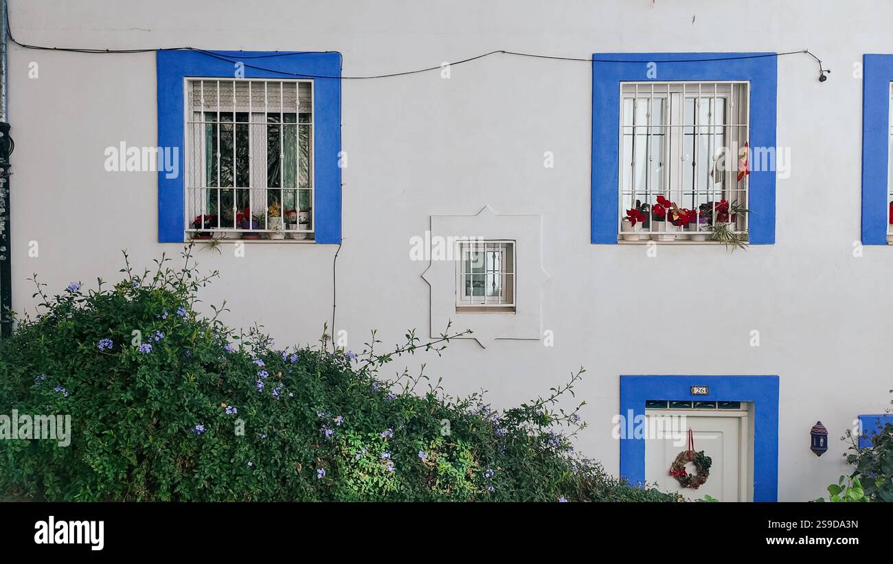 A typical residential house in Granada, Spain, featuring a white wall ...