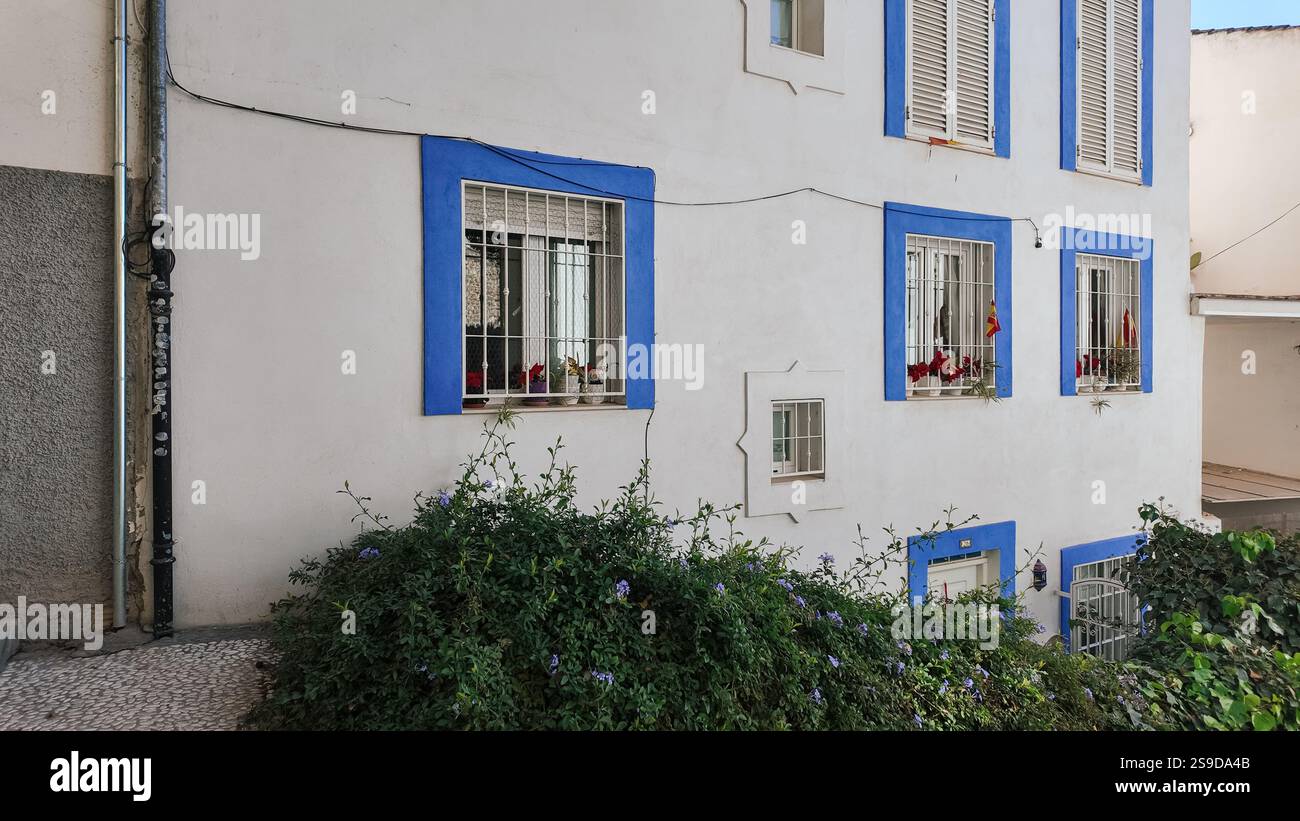 A typical residential house in Granada, Spain, featuring a white wall ...