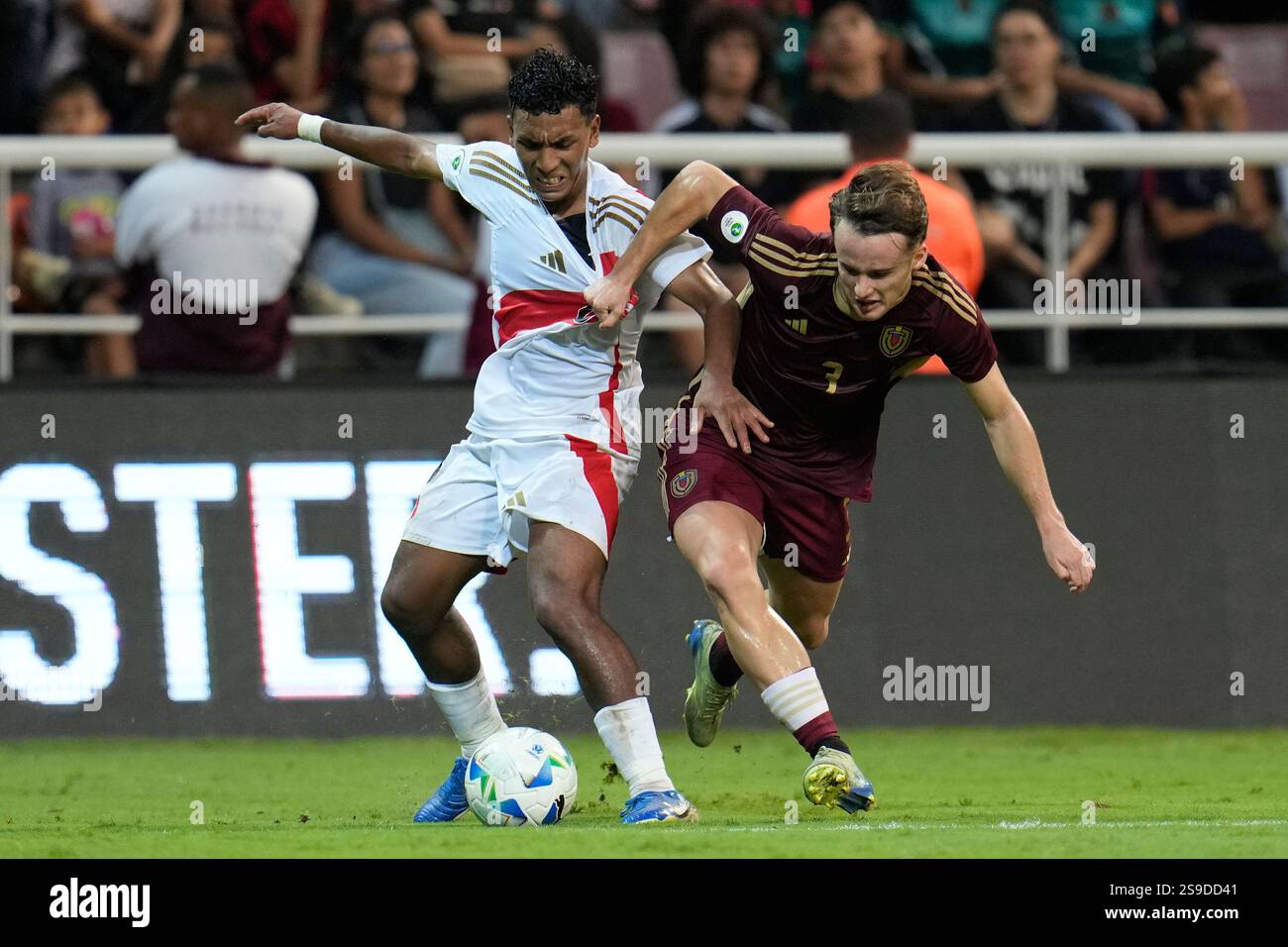 Venezuela's Alessandro Milani, right, grabs Peru's Alvaro Rojas, left ...