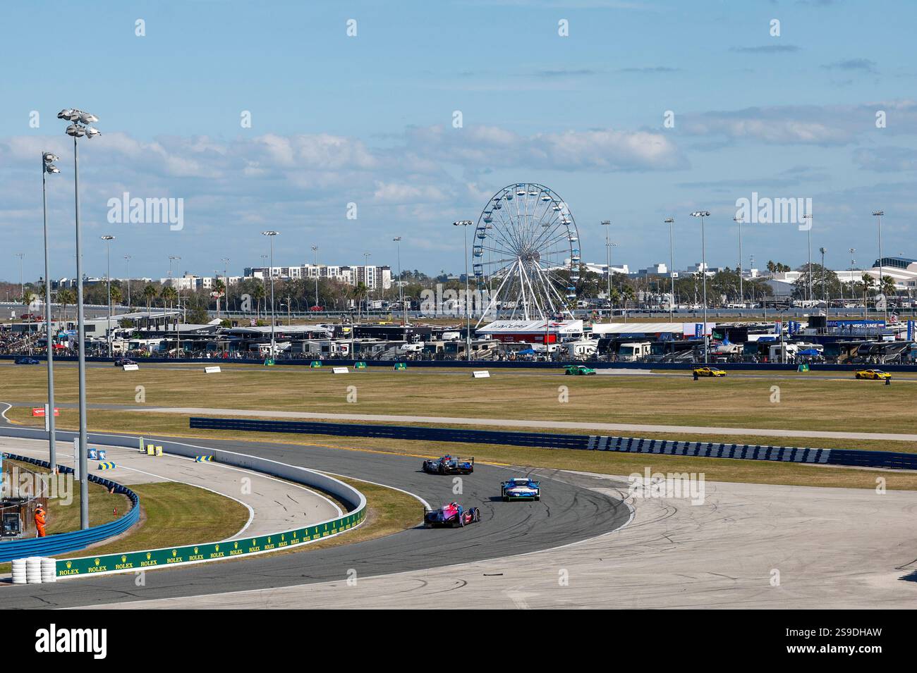 DAYTONA BEACH, FL - JANUARY 25: Cars race into a turn during the Rolex ...