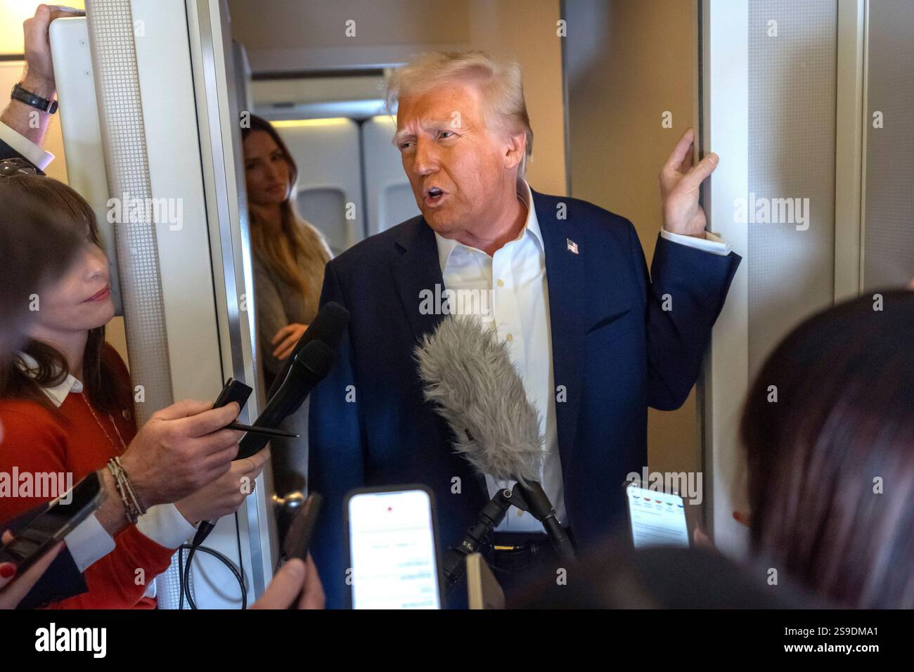 President Donald Trump speaks to reporters aboard Air Force One as he ...