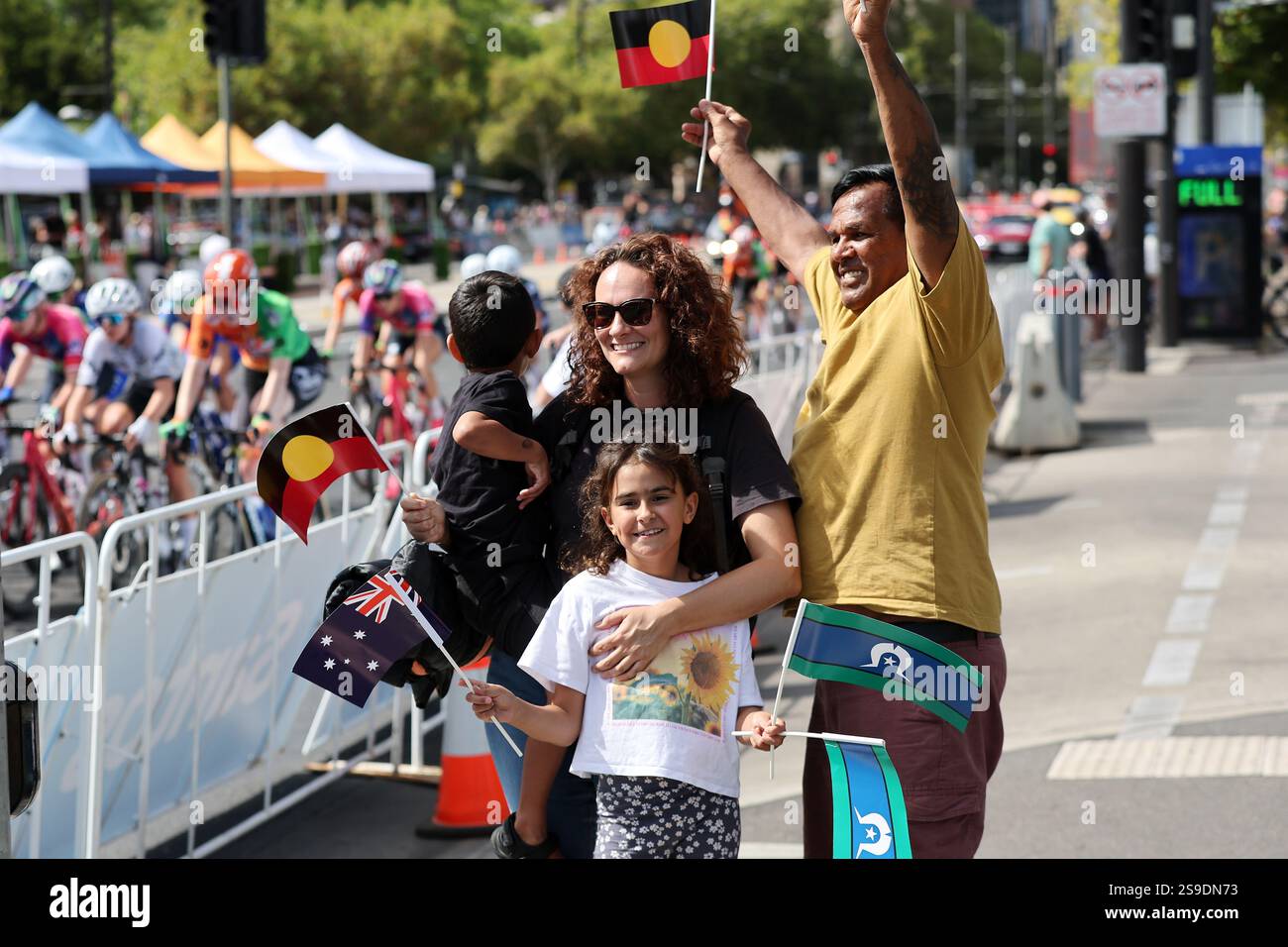 Spectators with flags watch the race go by during the Santos Women's