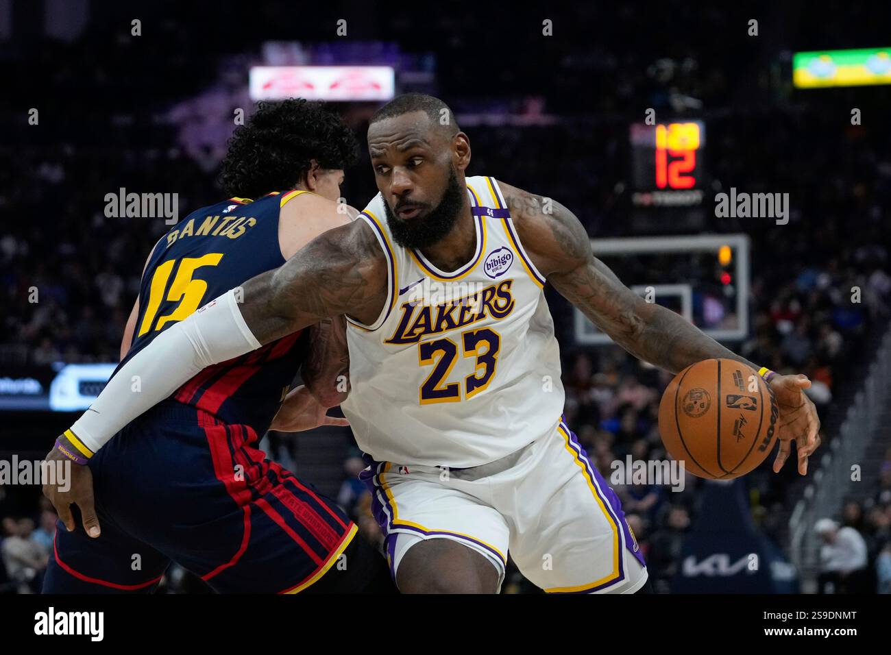 Los Angeles Lakers forward LeBron James, right, moves the ball while
