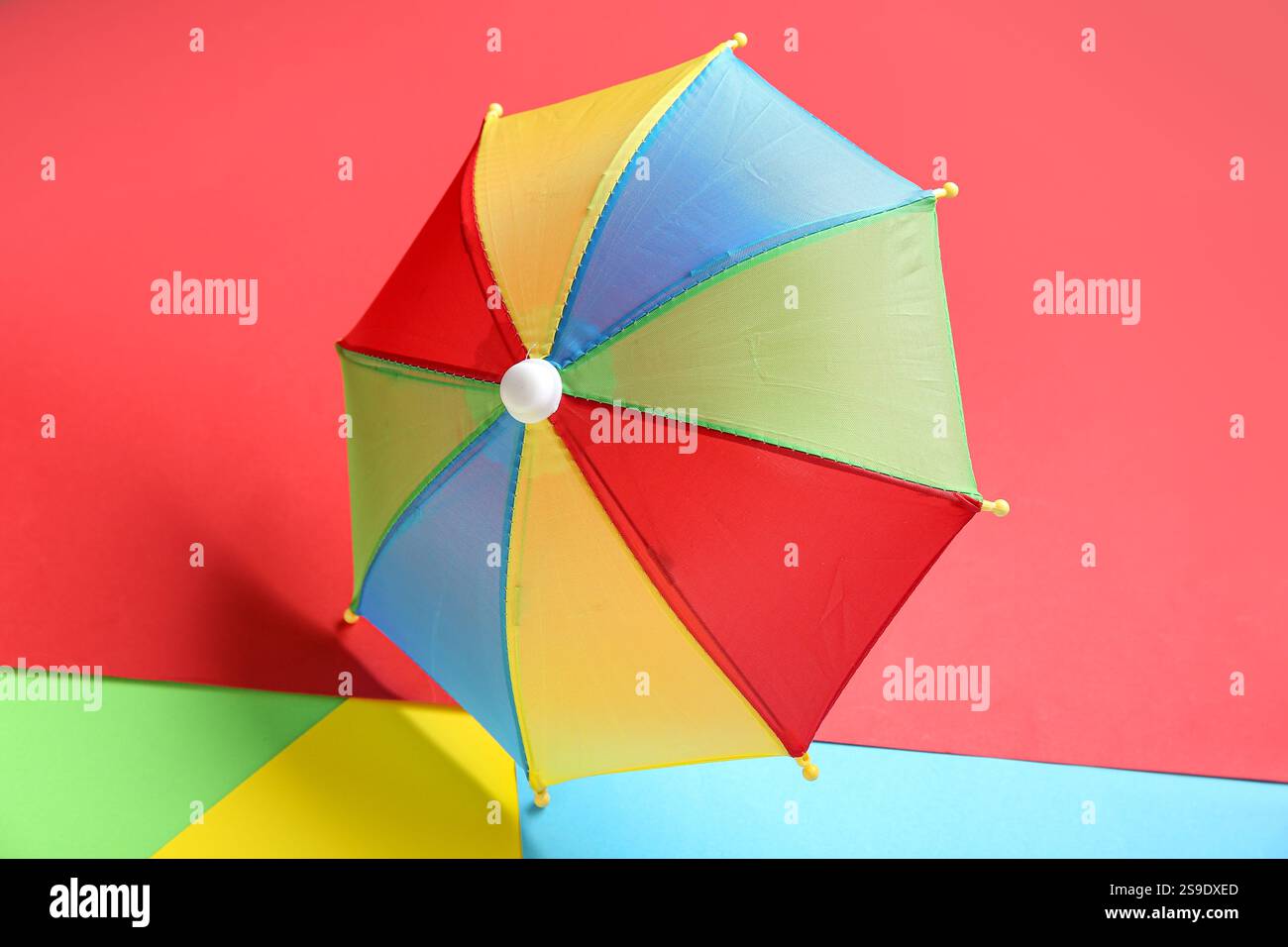 Colorful mini umbrella on color background Stock Photo