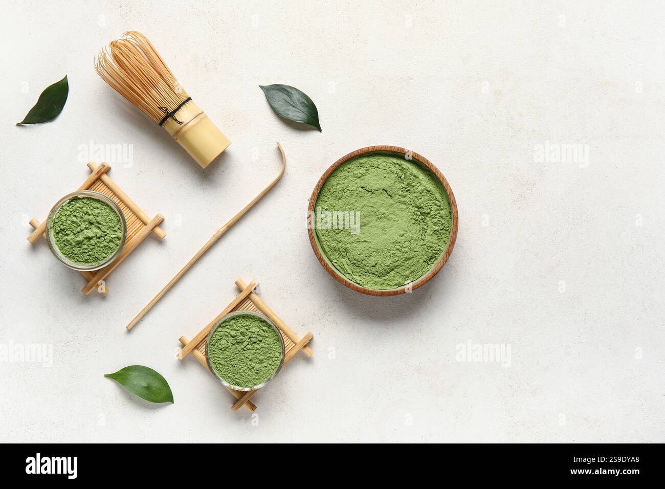 Composition with powdered matcha tea and accessories on light background Stock Photo