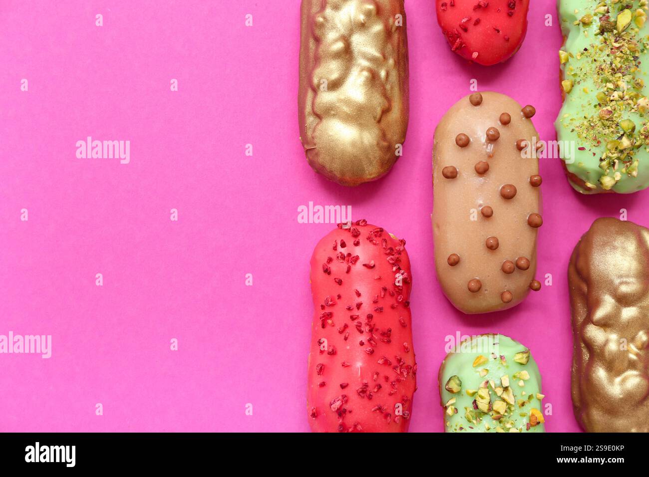 Composition with tasty glazed eclairs on pink background Stock Photo