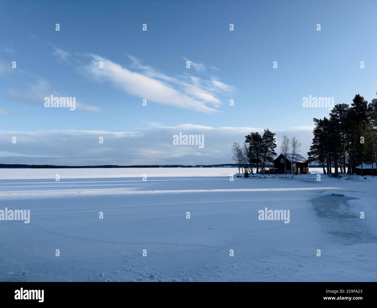 Frozen lake and a small cabin in north Sweden - Smartphone Captured Stock Image