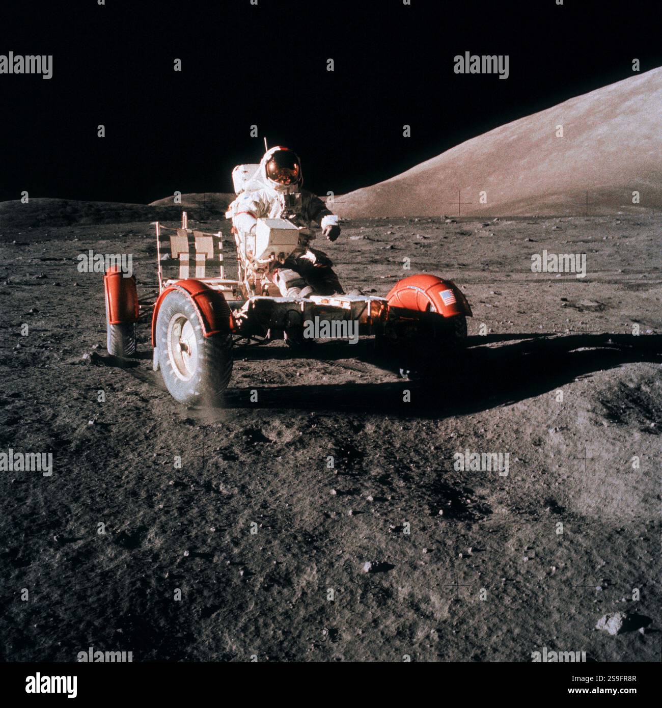 Astronaut Eugene A. Cernan, commander, drives the Lunar Roving Vehicle ...