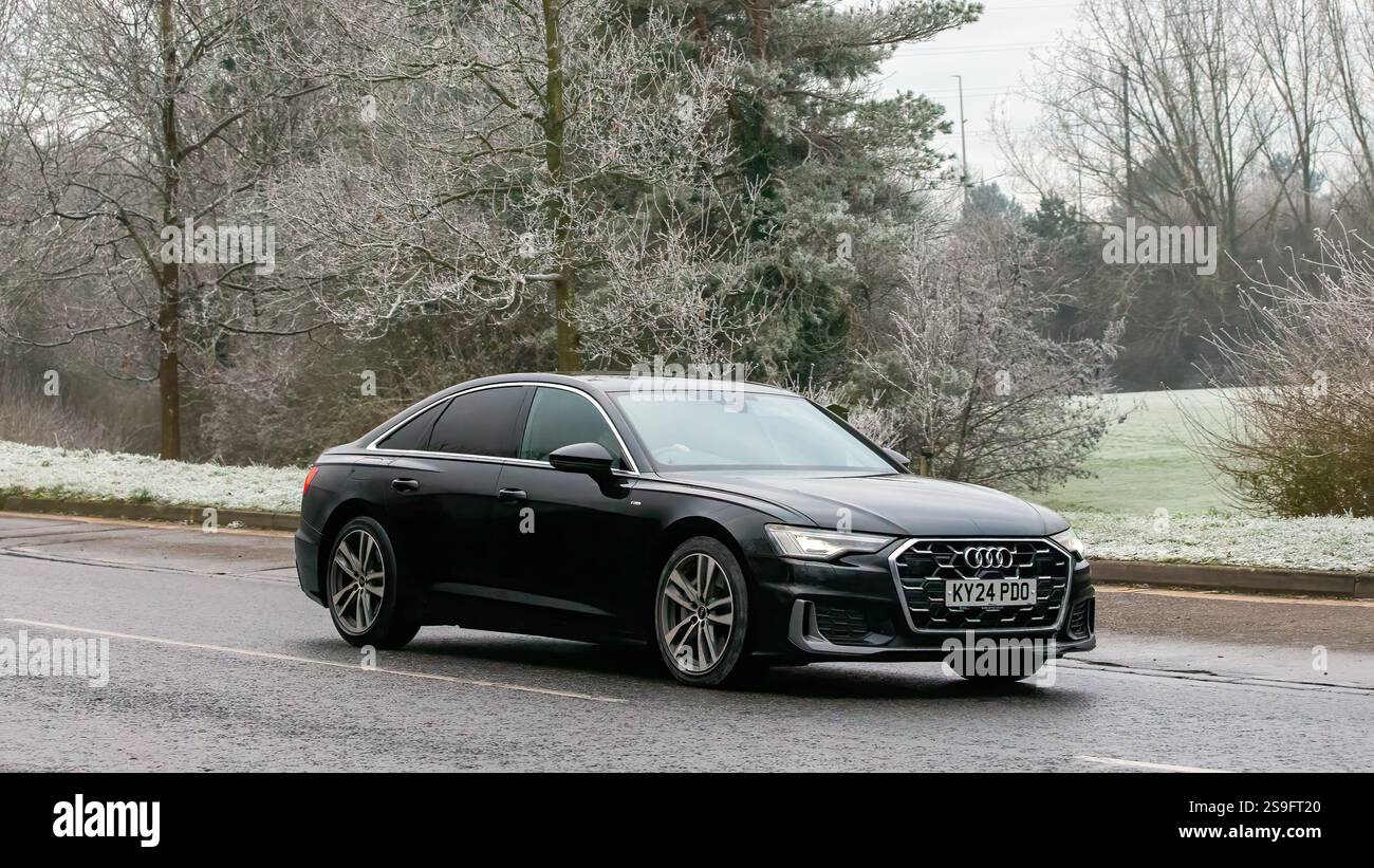 Milton Keynes,UK - Jan 12th 2025:2024 AUDI A6  hybrid electric car driving on a cold,frosty morning Stock Photo