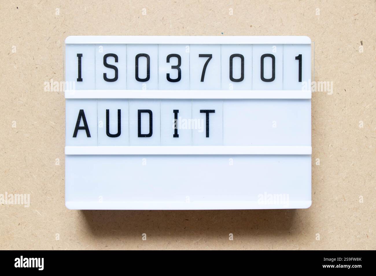 Lightbox with word ISO 37001 audit on wood background Stock Photo