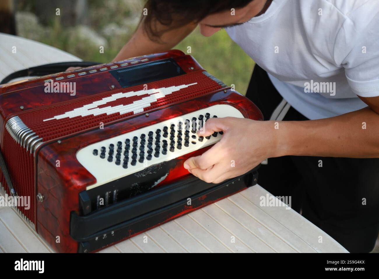 Man Testing All The Buttons Of His Accordion Stock Photo - Alamy