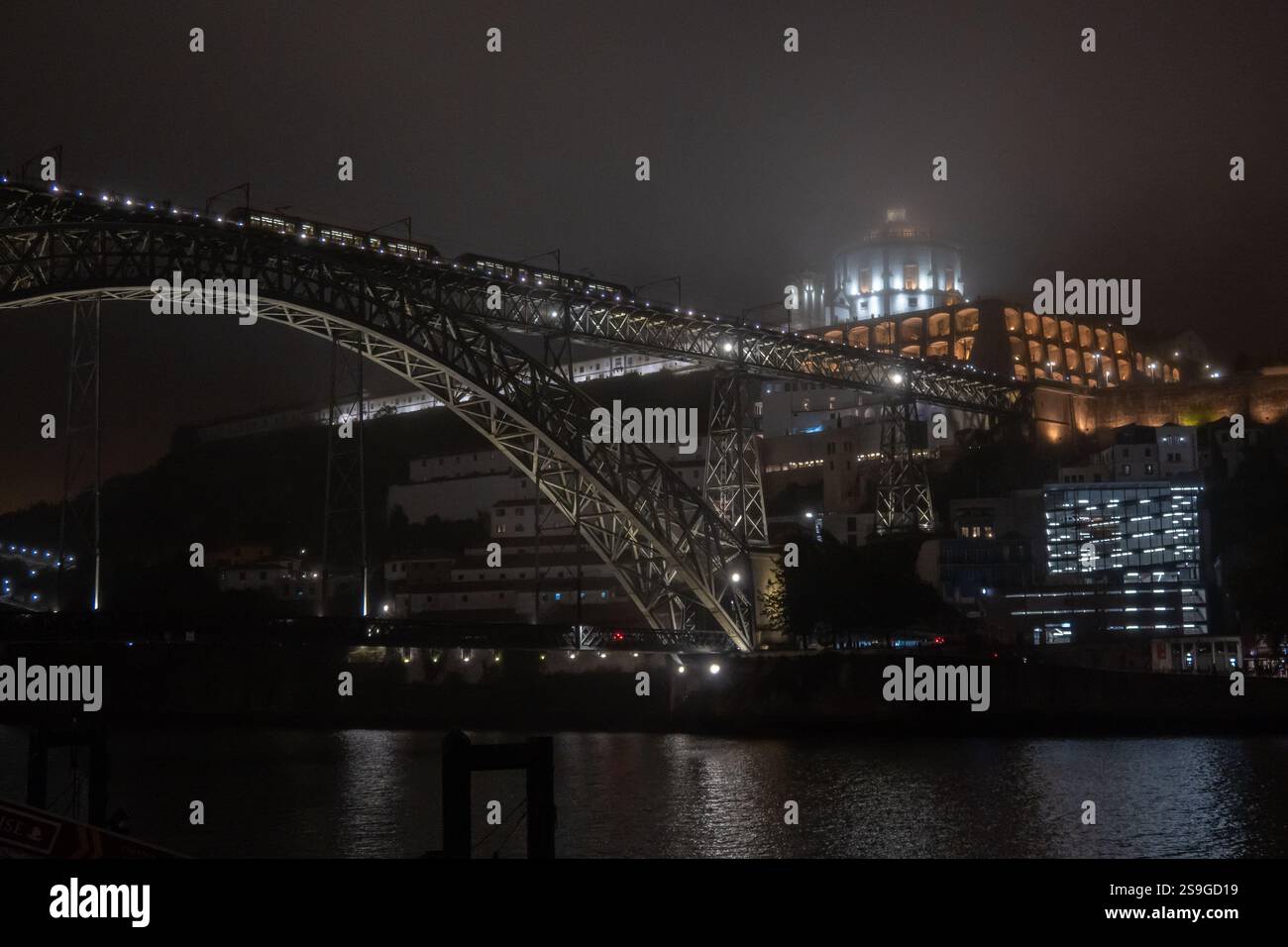 Dom Luis bridge and Mosteiro Santo Agostinho da Serra do Pilar in mist at night Oporto Portugal Stock Photo
