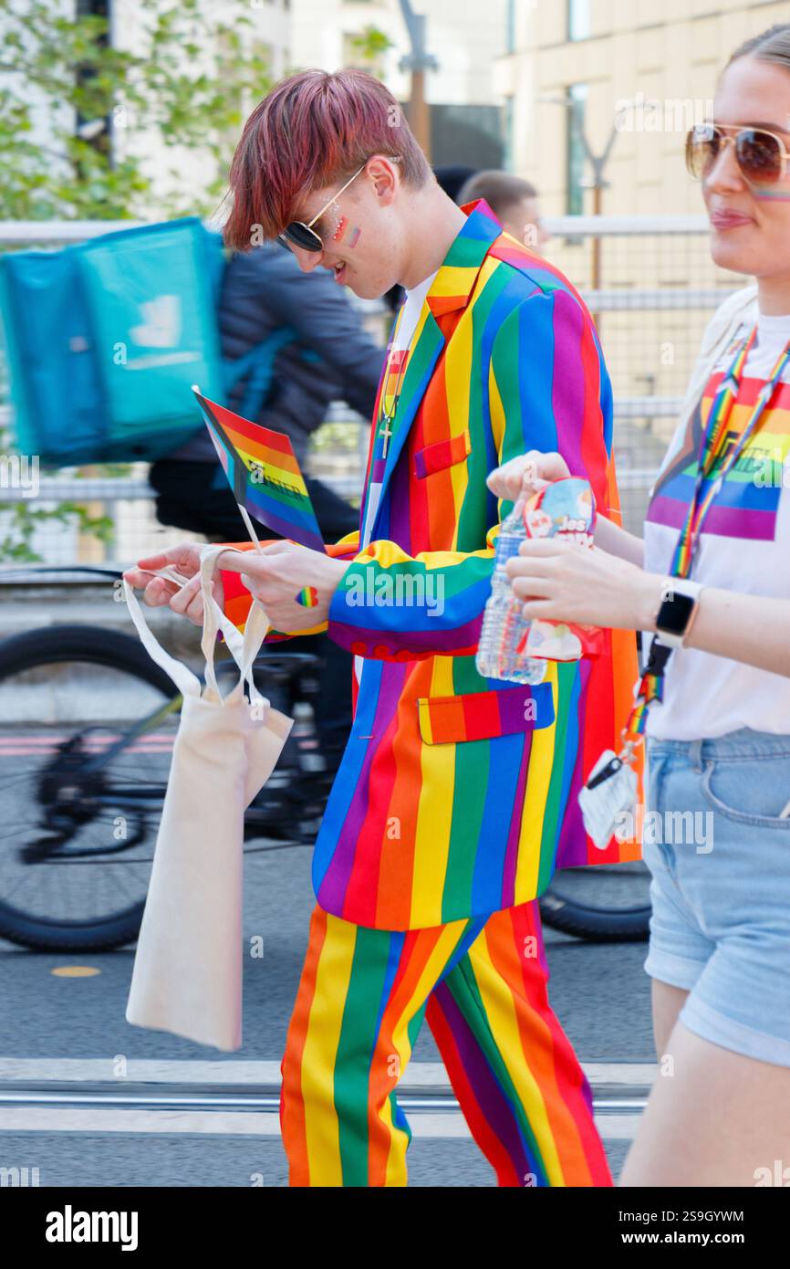 young man in rainbow striped pride suit at Birmingham Pride celebrating LGBT+ diversity and equality Stock Photo