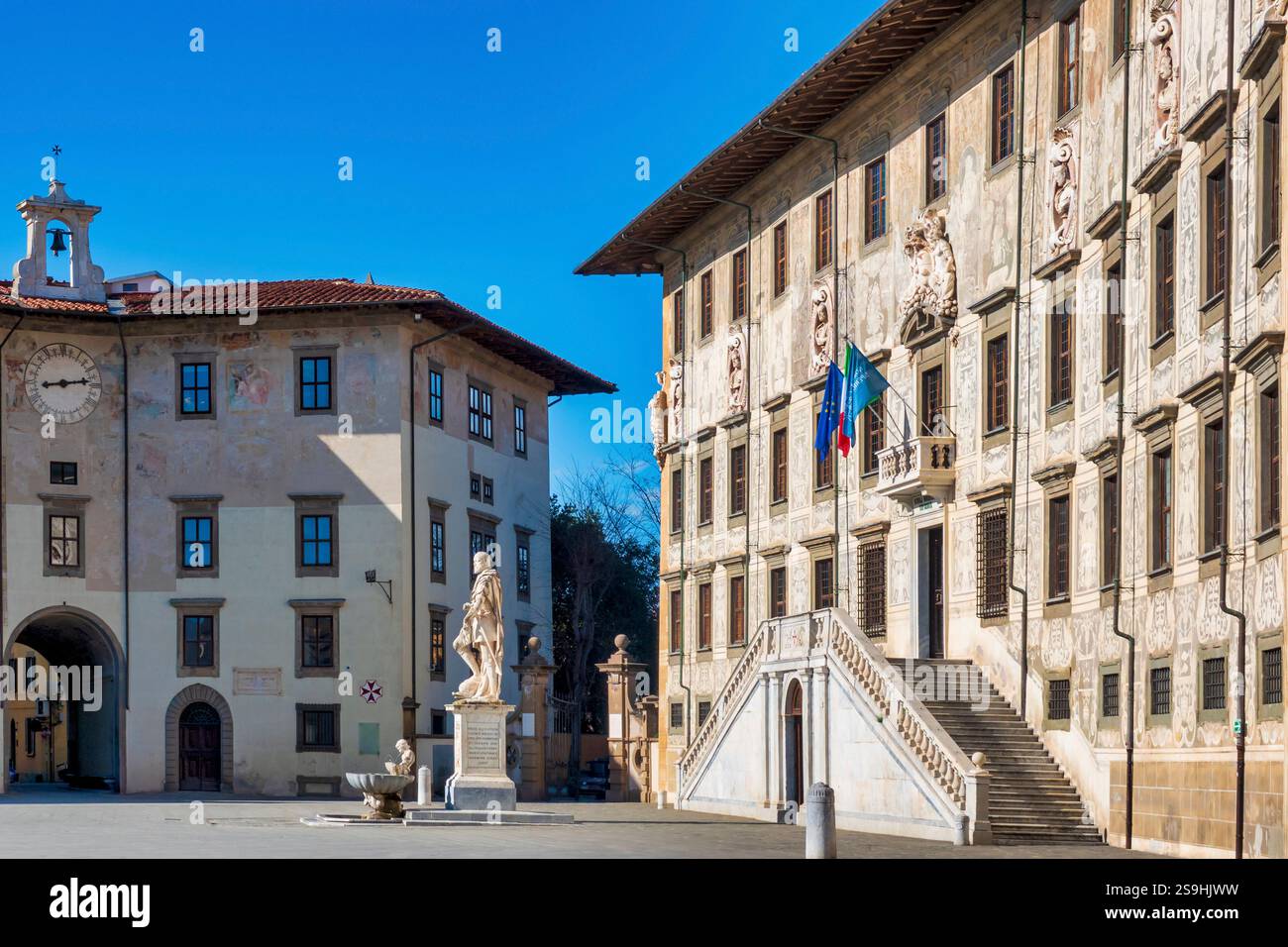 Piazza dei Cavalieri in Pisa, Italy, features the Palazzo della Carovana on the right and the Palazzo dell'Orologio on the left, both exemplifying Ren Stock Photo