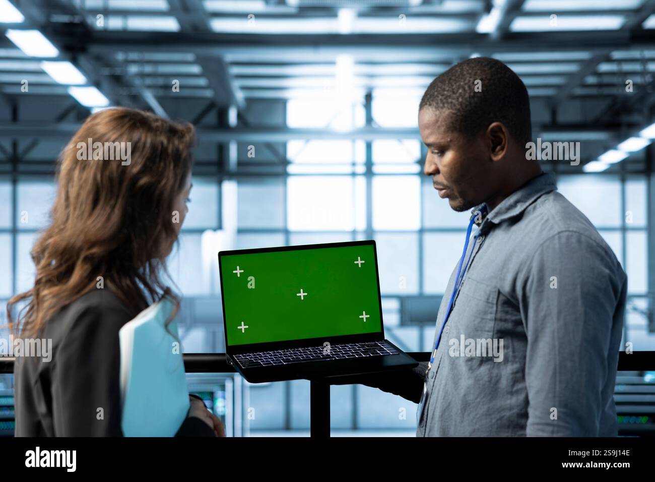 Mockup notebook used by data center system administrators reviewing equipment diagnostics. Close up of chroma key device used by team of IT specialists adjusting server farm configurations Stock Photo