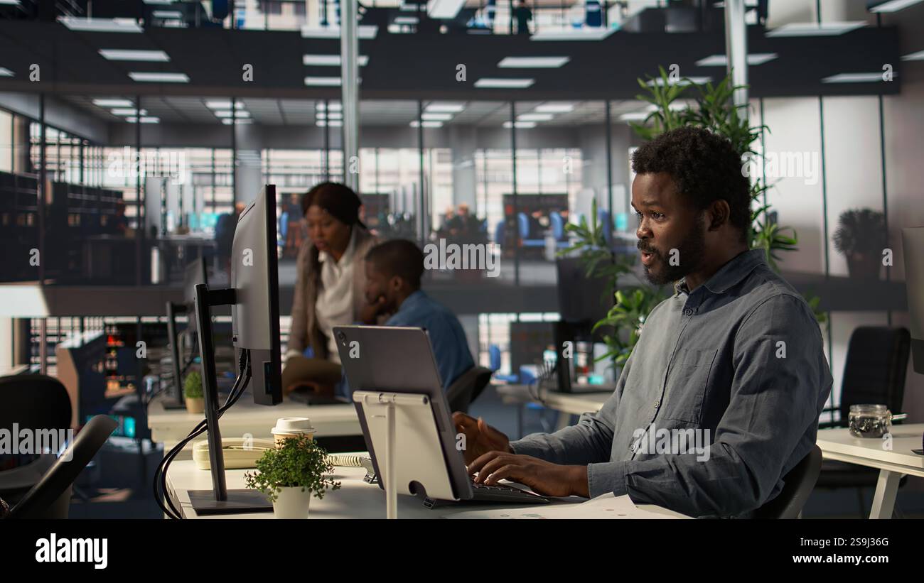 Professional black director leading a video conference with his staff ...