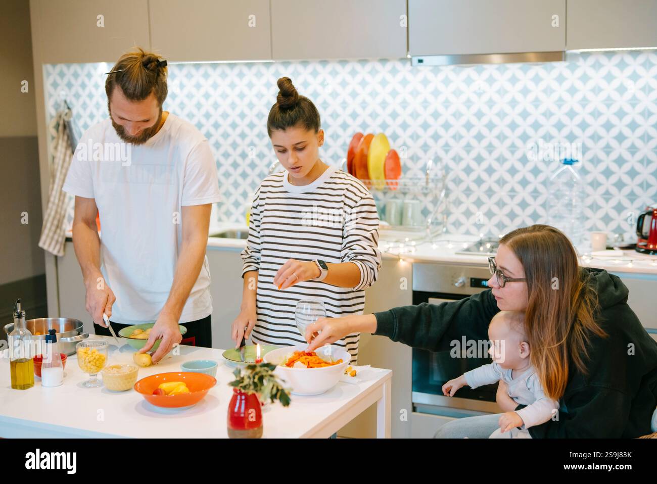 Everyone in the family gathers together to cook a delightful meal in a ...