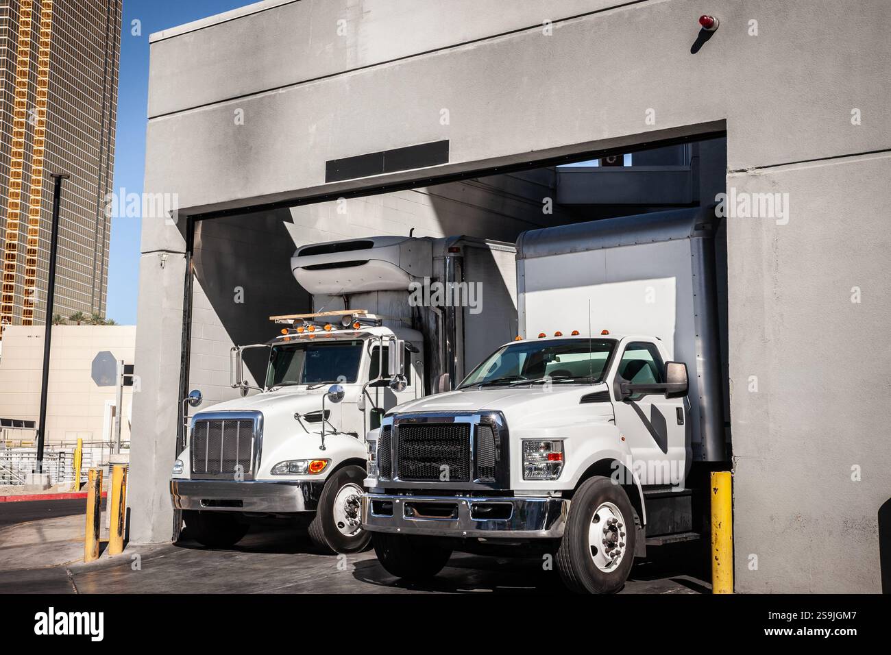 LAS VEGAS - AUGUST 23, 2024: Delivery trucks at a Las Vegas warehouse loading zone managing freight & unloading tasks in this commercial facility, ref Stock Photo