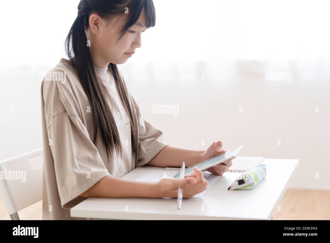 Junior high school students studying at home Stock Photo - Alamy