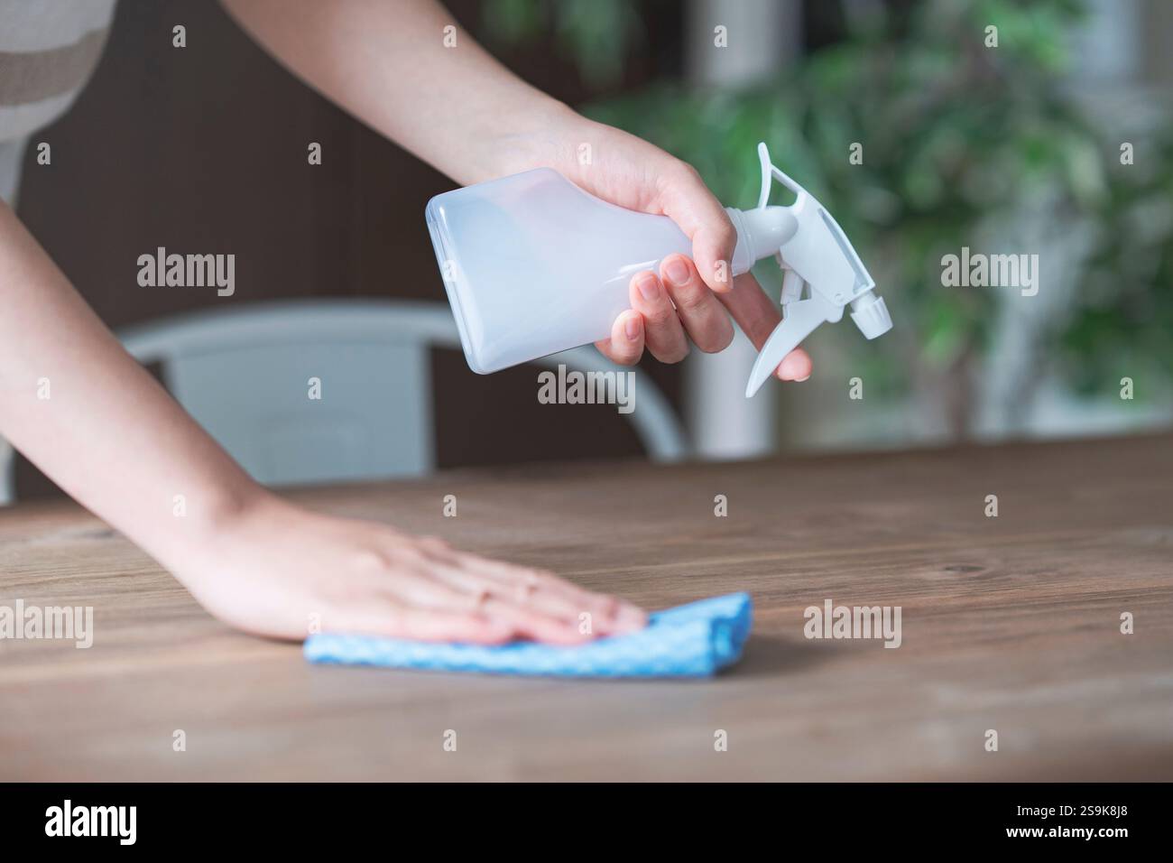 Disinfecting table with spray Stock Photo - Alamy
