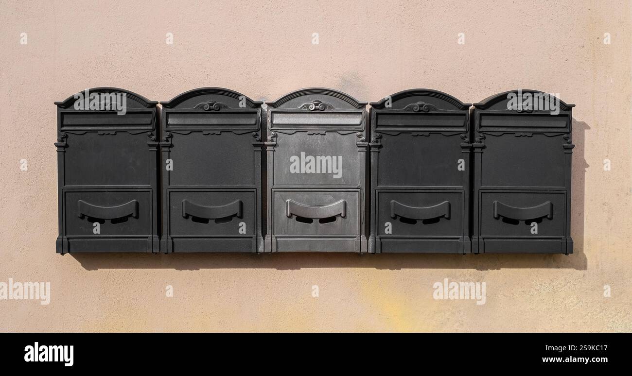 Private mailboxes hanging on old wall Stock Photo