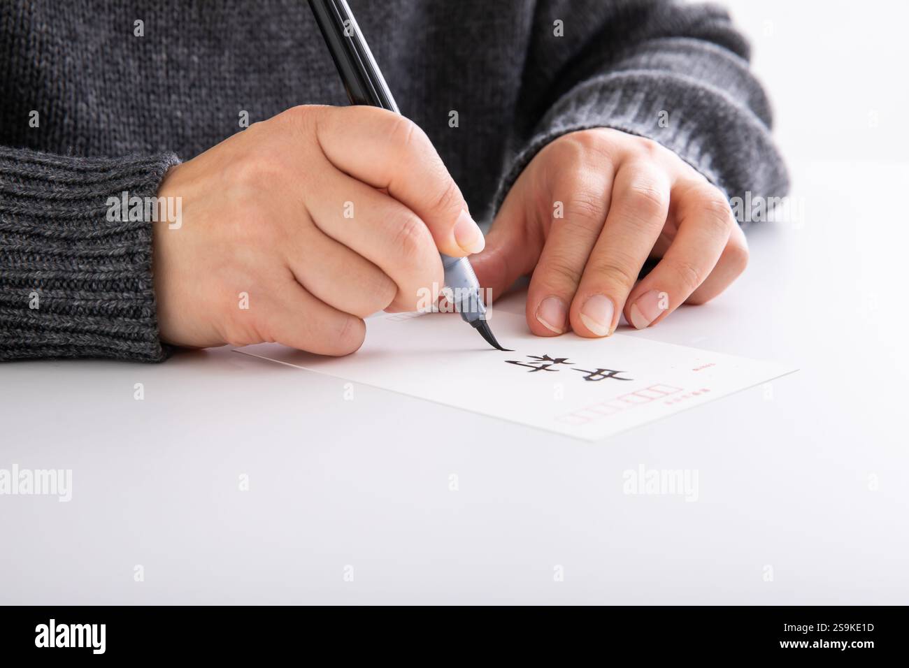 Hand Addressing Woman's hand addressing a postcard with a brush Stock Photo - Alamy