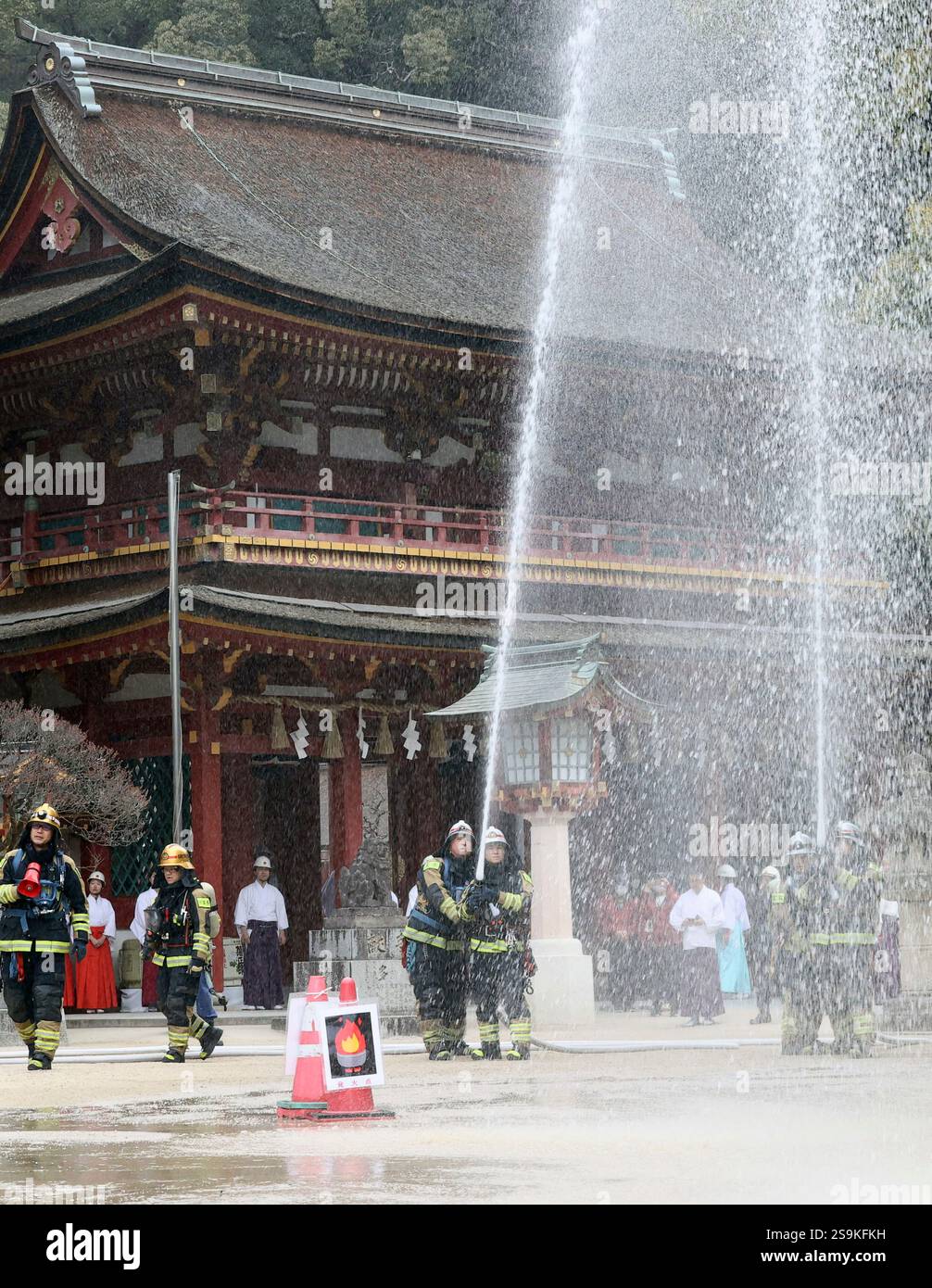Firefighting Open Water Relay Priests and shrine maiden conduct a firefighting drill at the ground of ...
