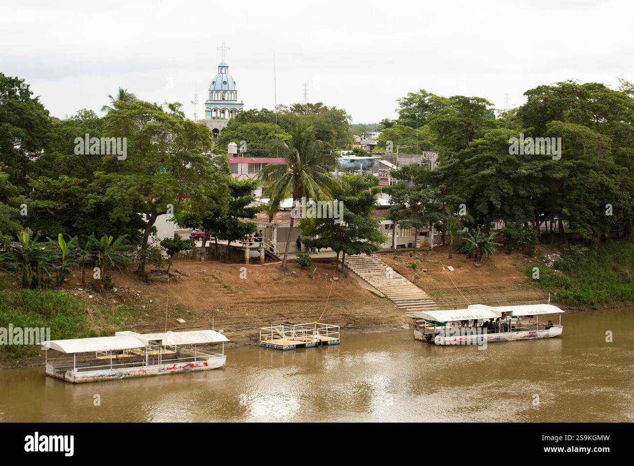 Villahermosa, Tabasco, Mexico - January 6, 2019: Boats dock along the Grijalva River with the city skyline rising in the distance. Stock Photo