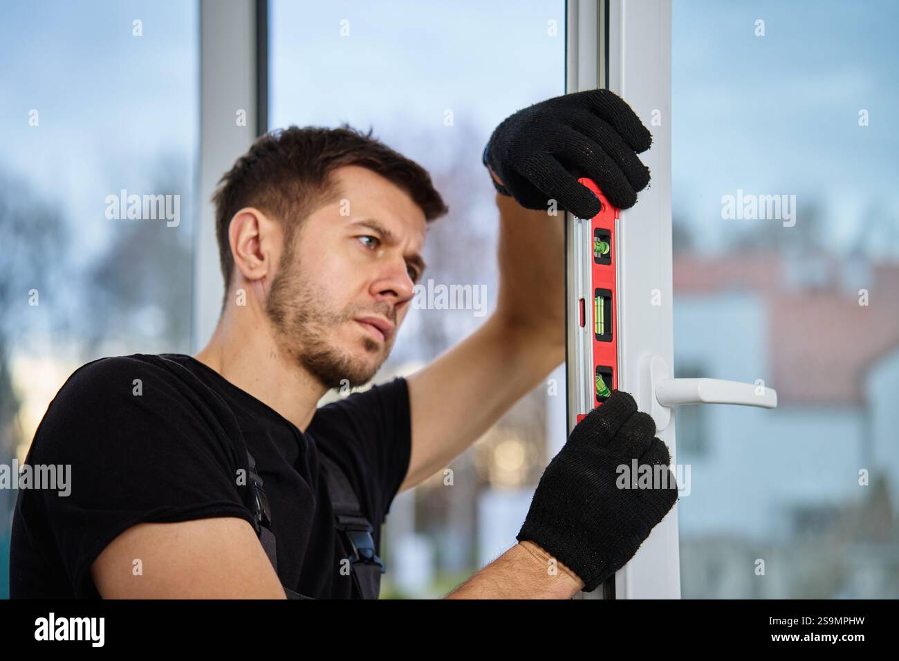 Professional builder using red spirit hi-res stock photography and ...