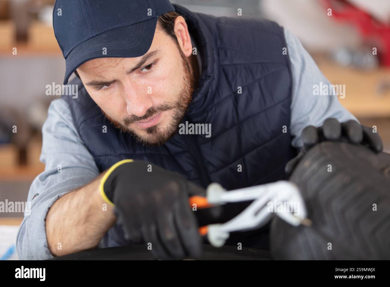 mechanician changing car wheel in auto repair shop Stock Photo - Alamy