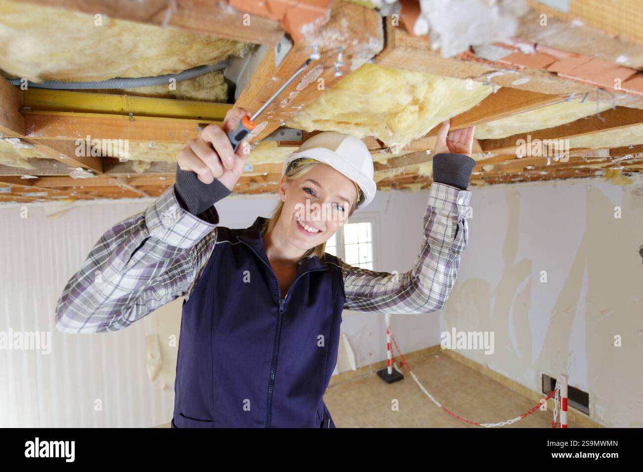 female constractor working and using screwdriver Stock Photo