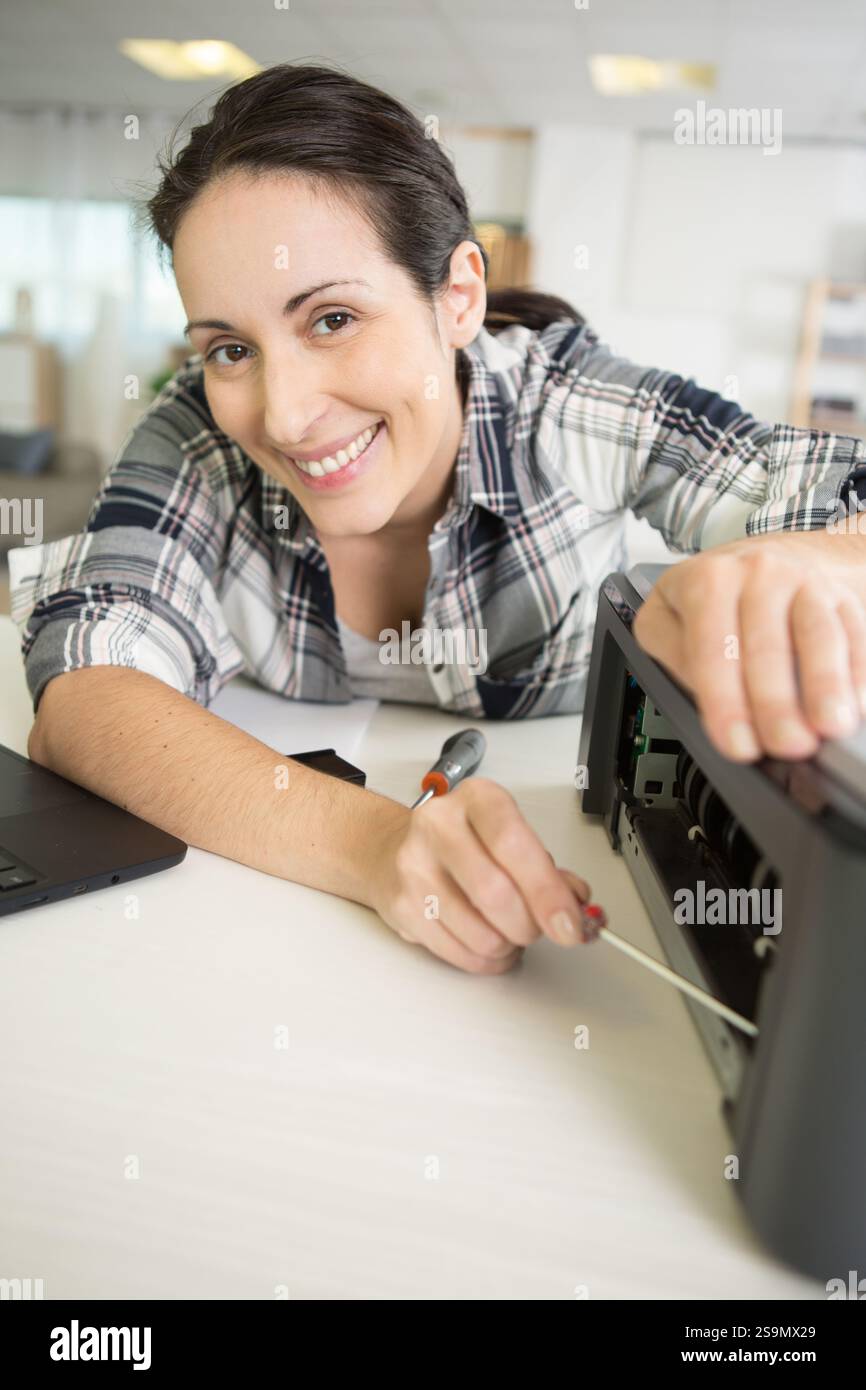 female technician fixing printer Stock Photo