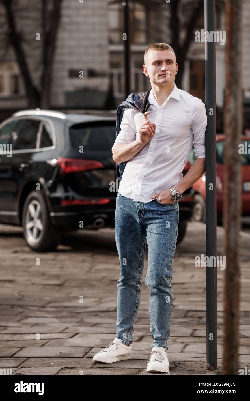 Stylish Young Man Posing Casually on Urban Street Stock Photo - Alamy