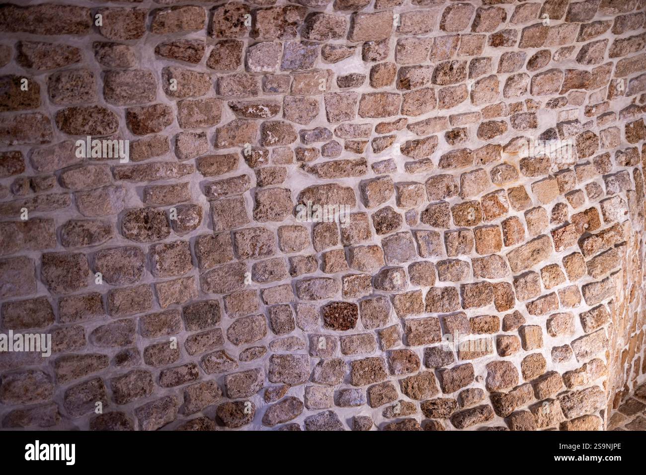 A stone wall of an old house from the early 13th century. An example of ...