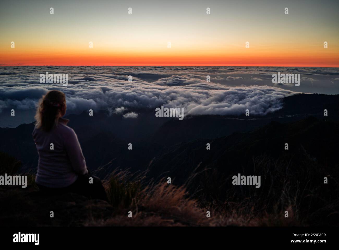 Hiker’s Dream - Watching the Sky Unfold at Dawn Stock Photo