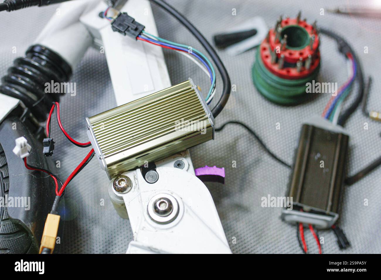Close-up of electrical and mechanical components of a scooter, focused