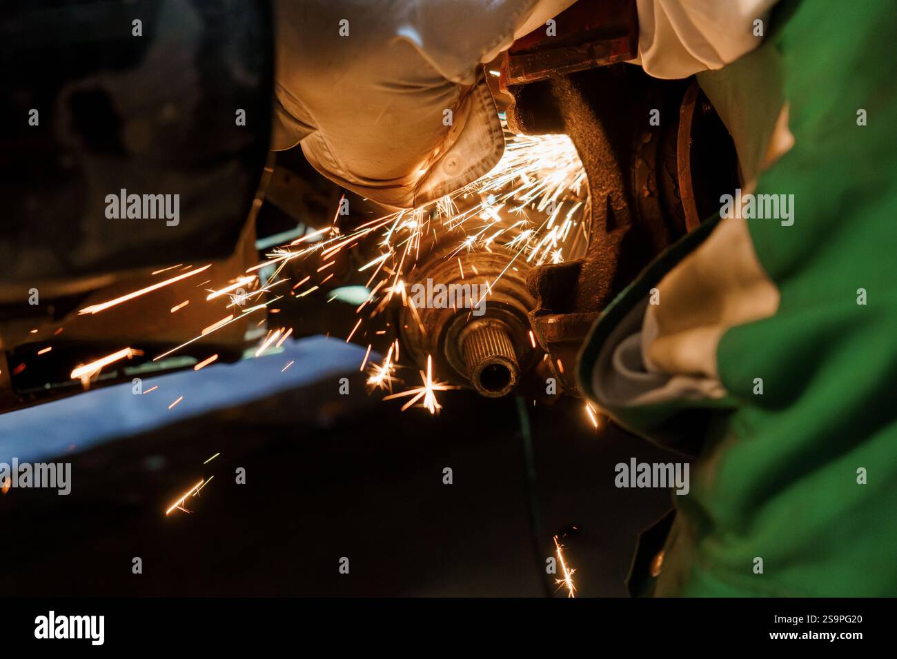 Sparks Fly as a Mechanic Performs Precision Metal Work. Stock Photo