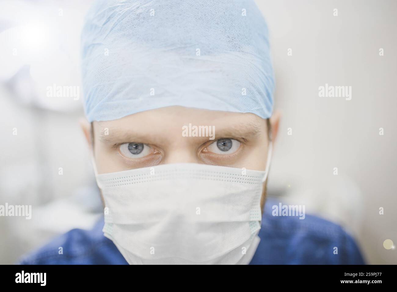 Wearing a surgical light blue mask hi-res stock photography and images ...