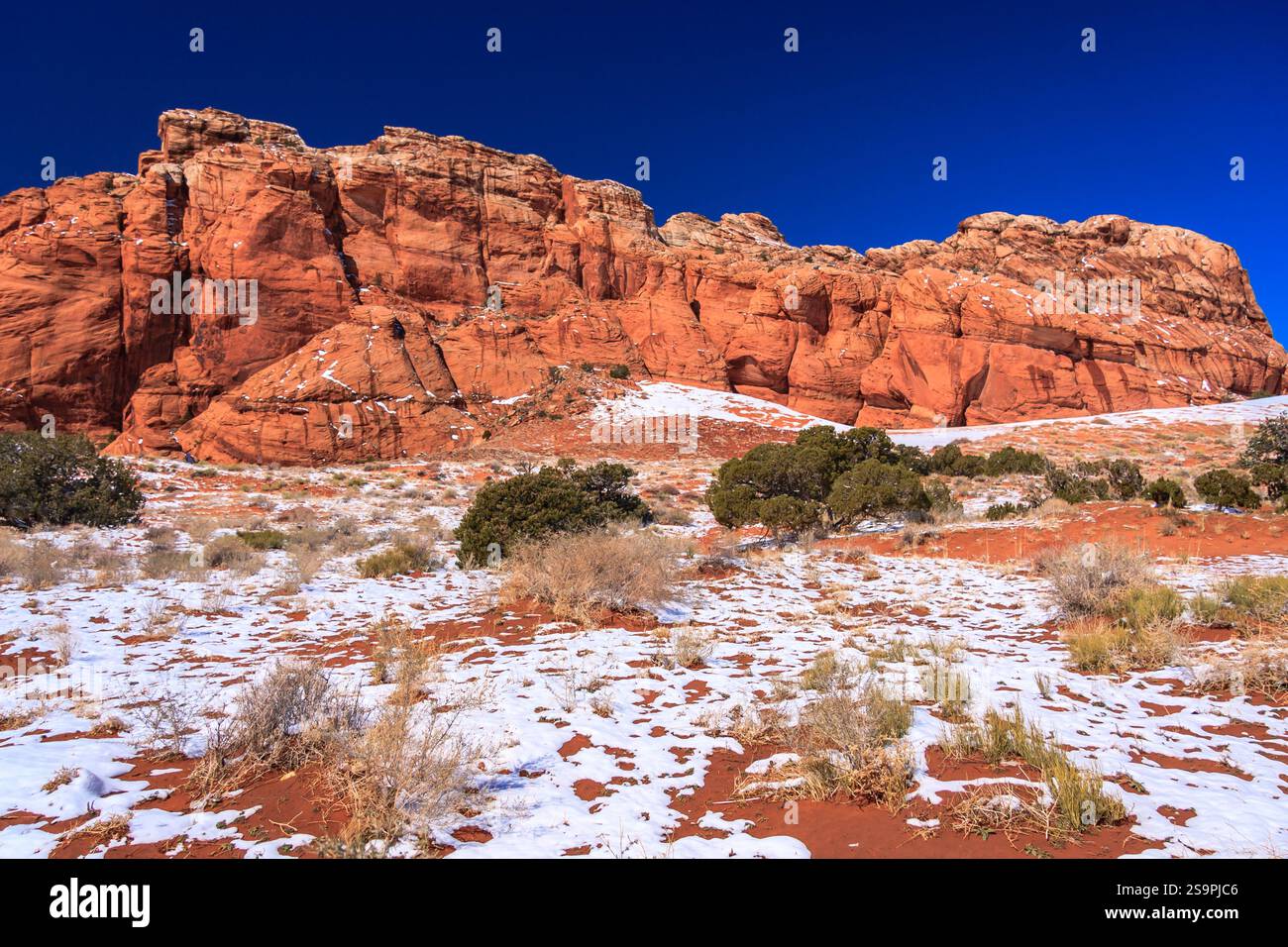 A mountain range covered in snow and rocks. The snow is covering the ...