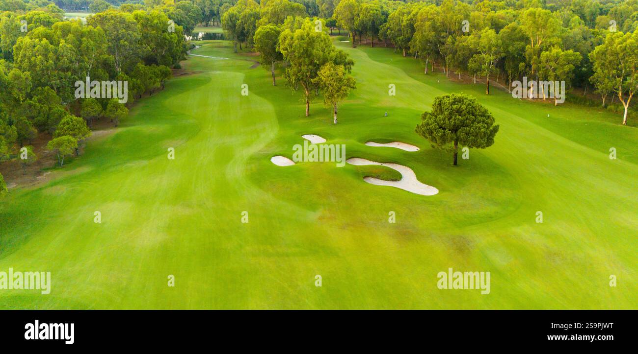 An aerial view of a golf course with sand traps and vibrant greenery ...