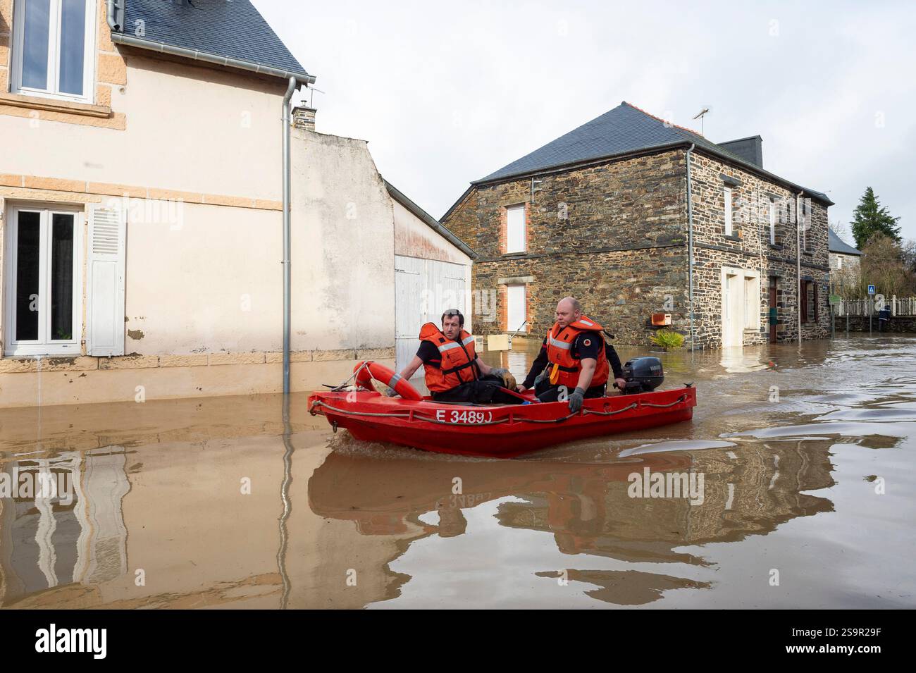 Rescue workers sit in a small boat after the storm Herminia has ...