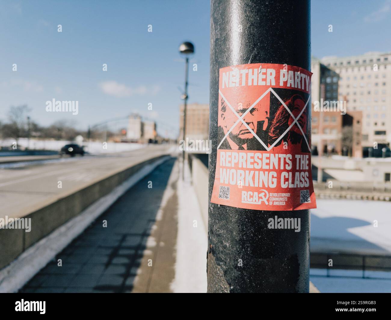 A sticker on a lamp post in Flint Michigan USA, reading Neither Party Represents the Working Class, for the Revolutionary Communists of America - Smartphone Captured Stock Image